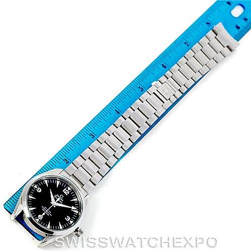 The image shows an Omega Aqua Terra 2503.52.00 Men
s Stainless Steel Black Dial 2503.52.00 Men
s Stainless Steel Black Dial watch with a metal bracelet laid next to a blue ruler for measurement.