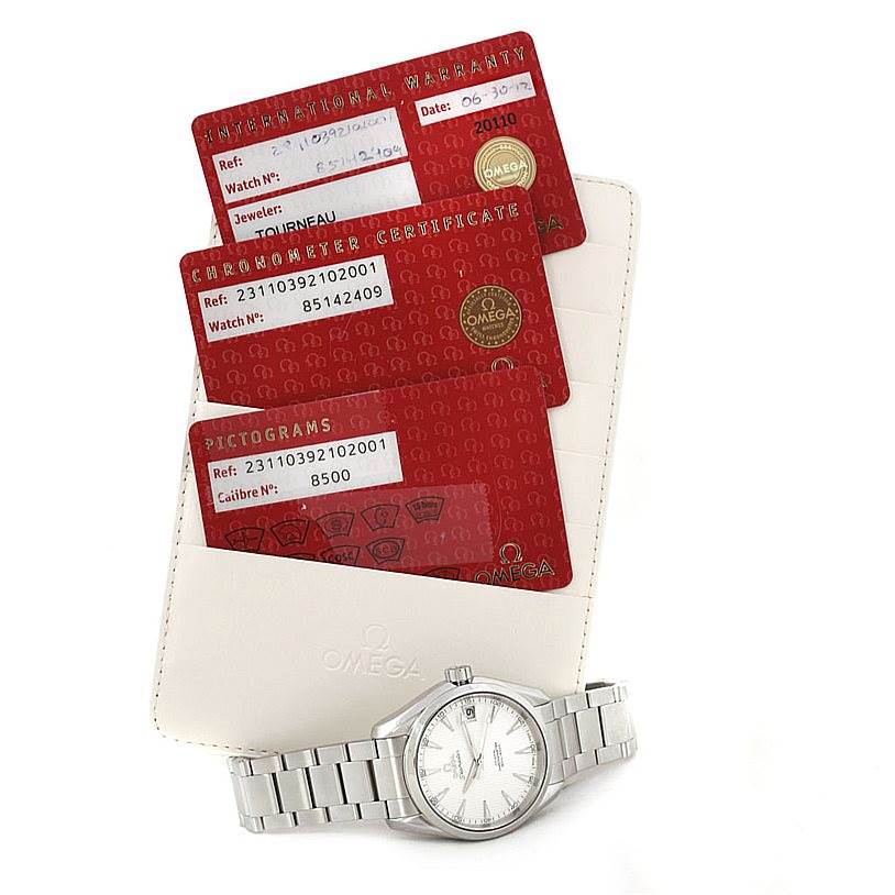 The image shows an Omega Aqua Terra 231.10.39.21.02.001 Men
s Stainless Steel Silver Dial 231.10.39.21.02.001 Men
s Stainless Steel Silver Dial watch and some warranty cards taken from a top-down angle.