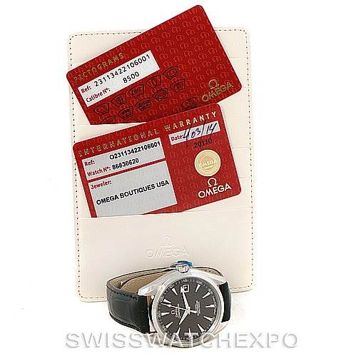 The image shows an Omega Aqua Terra 231.13.42.21.06.001 Men
s Stainless Steel Grey Dial 231.13.42.21.06.001 Men
s Stainless Steel Grey Dial watch and its warranty cards, displayed at an angle that shows the watch face and leather strap.