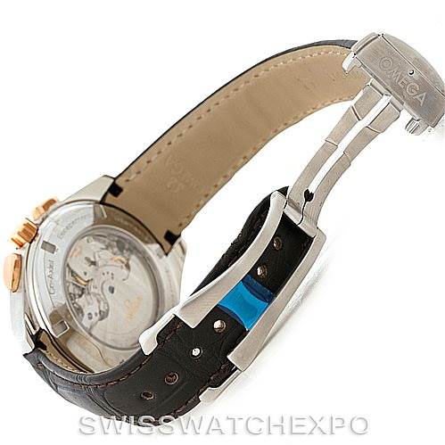 The image shows the back view of an Omega Aqua Terra 231.23.44.50.06.001 Men's Steel and Gold (two tone) Grey Dial 231.23.44.50.06.001 Men's Steel and Gold (two tone) Grey Dial watch, highlighting the clasp, strap, and transparent case back.