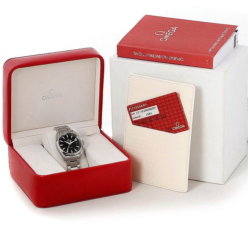 The image shows a sideways view of the Omega Aqua Terra 231.10.39.60.06.001 Men
s Stainless Steel Grey Dial 231.10.39.60.06.001 Men
s Stainless Steel Grey Dial watch in its red box with accompanying warranty card and instruction manual.