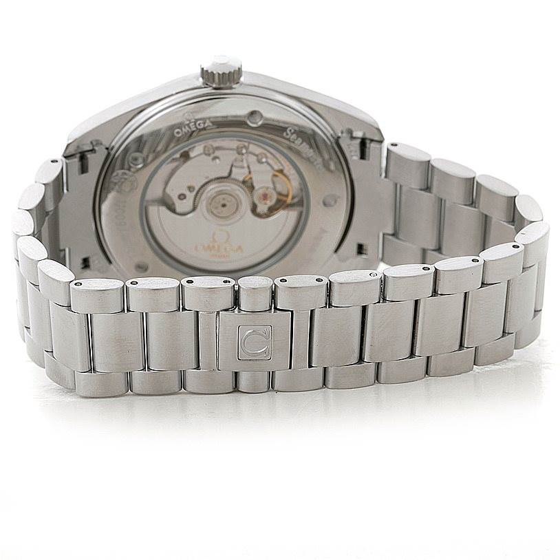 The image shows the back of the Omega Aqua Terra 2502.34.00 Men
s Stainless Steel Silver Dial 2502.34.00 Men
s Stainless Steel Silver Dial watch and its metal bracelet, displaying the watch
s mechanical movement.