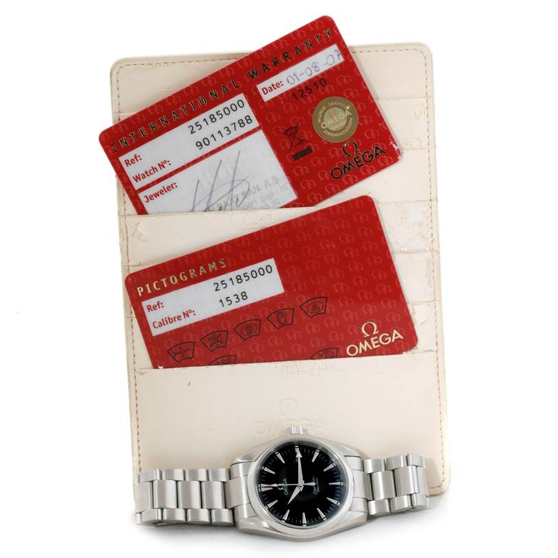 This image shows an Omega Aqua Terra 2502.30.00 Men's Stainless Steel Black Dial 2502.30.00 Men's Stainless Steel Black Dial watch with its bracelet, international warranty card, and pictograms card.