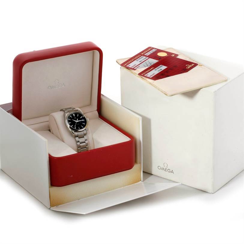 The image shows an Omega Aqua Terra 2502.30.00 Men's Stainless Steel Black Dial 2502.30.00 Men's Stainless Steel Black Dial watch from a front-angle view in its open box, with documentation beside it.