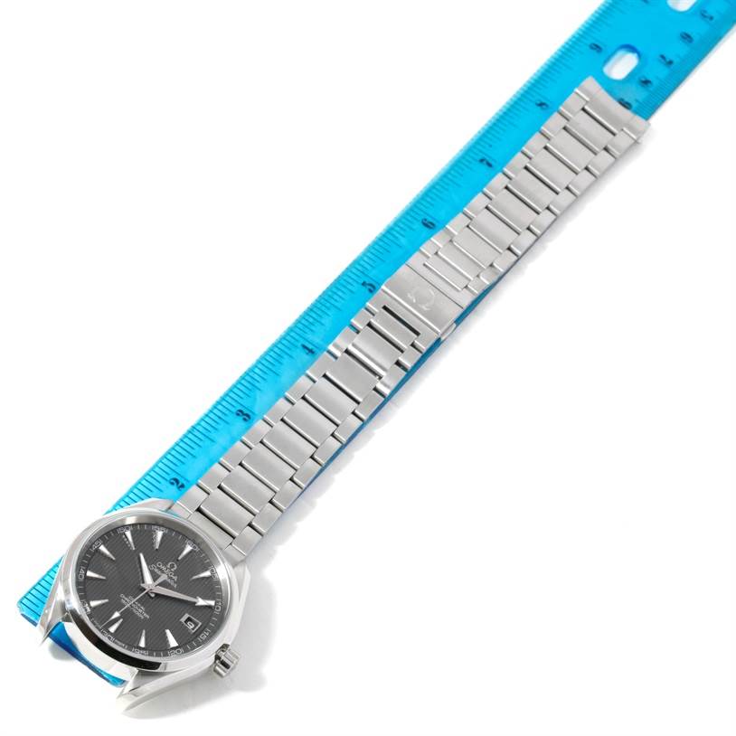 The Omega Aqua Terra 231.10.42.21.06.001 Men
s Stainless Steel Grey Dial 231.10.42.21.06.001 Men
s Stainless Steel Grey Dial watch is shown at an oblique angle, displaying the face, bezel, and metal bracelet fully extended alongside a ruler.