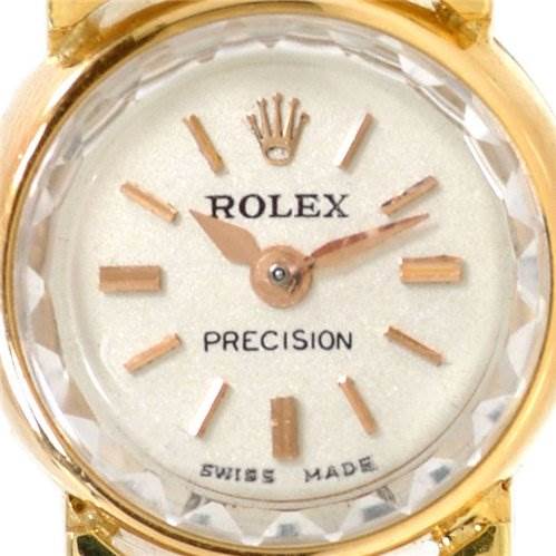 This is a close-up of the dial of the Rolex Cocktail 2113 Women's Yellow Gold Silver Dial 2113 Women's Yellow Gold Silver Dial model, showing the brand name, precision mark, and Swiss made label.
