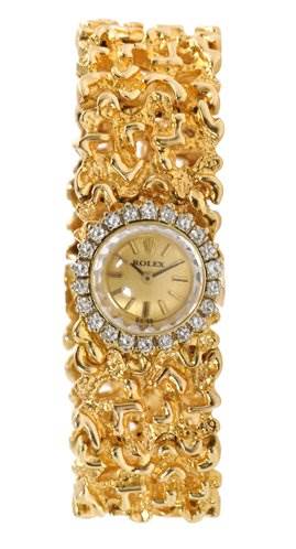 This image shows a Rolex Cocktail 2604 Women's Yellow Gold Champagne Dial 2604 Women's Yellow Gold Champagne Dial model watch from a top-down angle, highlighting its ornate gold strap and diamond-encrusted bezel.