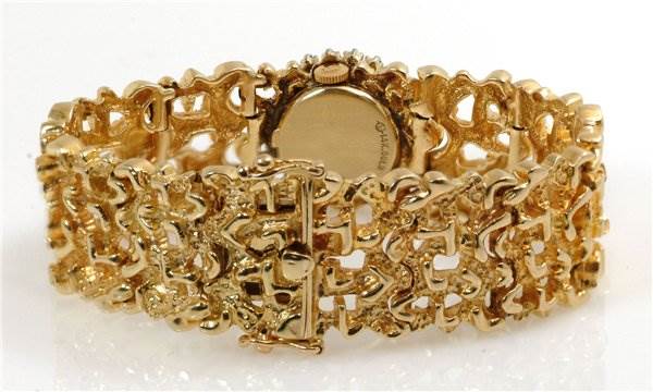 The image shows the back and band of a Rolex Cocktail 2604 Women's Yellow Gold Champagne Dial 2604 Women's Yellow Gold Champagne Dial model watch with intricate gold links.