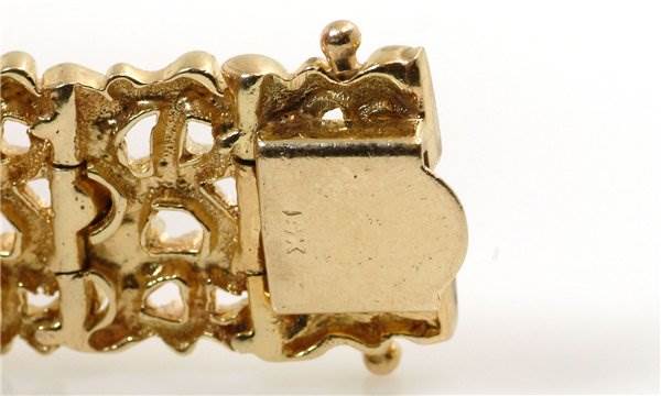 The image shows a close-up of the clasp of the Rolex Cocktail 2604 Women's Yellow Gold Champagne Dial 2604 Women's Yellow Gold Champagne Dial model watch, focusing on the intricate bracelet design and clasp mechanism.