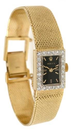 The image shows a Rolex Cocktail Women's Yellow Gold Black Dial Women's Yellow Gold Black Dial model watch with a gold strap and a rectangular face encrusted with diamonds, viewed from a slight side angle.