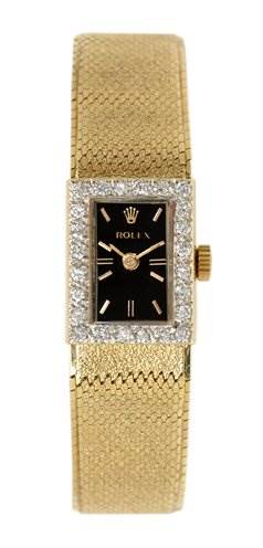 This image shows a Rolex Cocktail Women's Yellow Gold Black Dial Women's Yellow Gold Black Dial model watch from a front angle, highlighting its rectangular face, textured band, and ornate bezel.