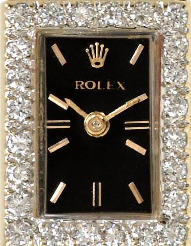 The image shows a close-up, front view of the Rolex Cocktail Women's Yellow Gold Black Dial Women's Yellow Gold Black Dial watch face, featuring a black dial with gold markers and a diamond-set bezel.