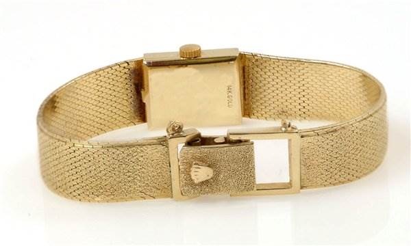 This image shows the back view of a Rolex Cocktail Women's Yellow Gold Black Dial Women's Yellow Gold Black Dial model watch, focusing on its clasp, bracelet, and case back.