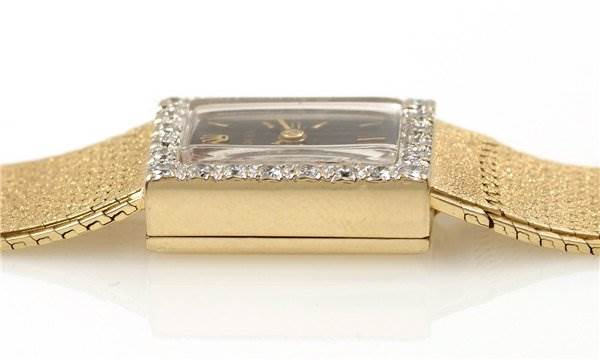 The image shows a side profile of the Rolex Cocktail Women's Yellow Gold Black Dial Women's Yellow Gold Black Dial model watch, highlighting the square case, crystal, and parts of the band.