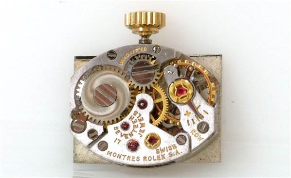 This image shows the intricate internal mechanical movement of a Rolex Cocktail Women's Yellow Gold Black Dial Women's Yellow Gold Black Dial model watch.