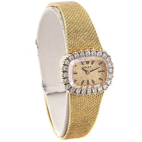 This image shows a side angle of a Rolex Cocktail 8365 Women's Yellow Gold Champagne Dial 8365 Women's Yellow Gold Champagne Dial model watch featuring a diamond-encrusted bezel and textured gold strap.