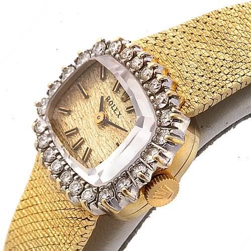 The image shows a Rolex Cocktail 8365 Women's Yellow Gold Champagne Dial 8365 Women's Yellow Gold Champagne Dial watch at an angled close-up, featuring its gold strap, diamond bezel, and crown.