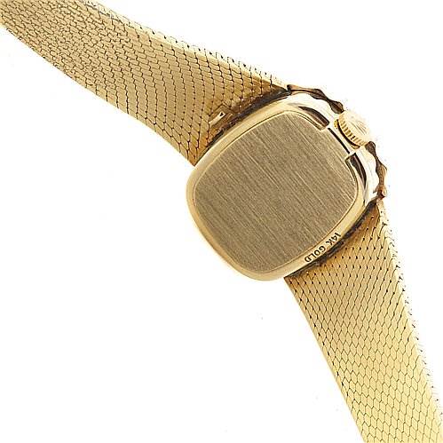 This image shows the back and band of the Rolex Cocktail 8365 Women's Yellow Gold Champagne Dial 8365 Women's Yellow Gold Champagne Dial watch at an angle revealing the case back and part of the bracelet.