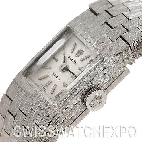 This image shows the face, bezel, and crown of a Rolex Cocktail 2189 Women's White Gold Silver Dial 2189 Women's White Gold Silver Dial watch from an angled side view.