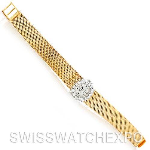 The image shows a full view of the Rolex Cocktail Women's Yellow Gold Silver Dial Women's Yellow Gold Silver Dial model watch with its gold mesh band and diamond-set bezel.