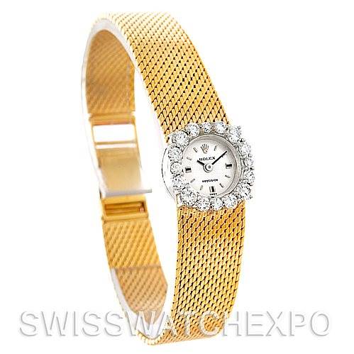 This image shows a Rolex Cocktail Women's Yellow Gold Silver Dial Women's Yellow Gold Silver Dial model watch from an angled side view, highlighting the diamond-encrusted face and gold mesh strap.