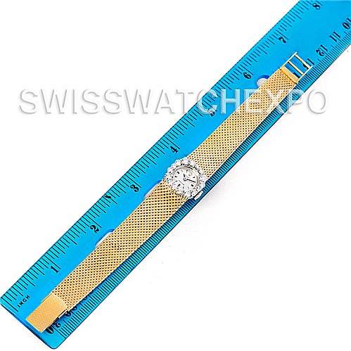 The Rolex Cocktail Women's Yellow Gold Silver Dial Women's Yellow Gold Silver Dial model watch is shown from a top-down angle lying next to a blue ruler, displaying the face and entire band.