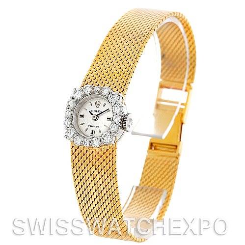 The image shows a Rolex Cocktail Women's Yellow Gold Silver Dial Women's Yellow Gold Silver Dial model watch from a side angle, highlighting its diamond bezel, mesh band, and clasp.