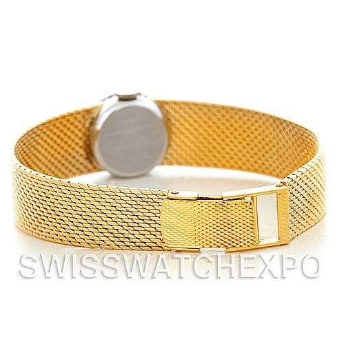 The image shows the back and clasp of the Rolex Cocktail Women's Yellow Gold Silver Dial Women's Yellow Gold Silver Dial model watch, highlighting its gold mesh bracelet.