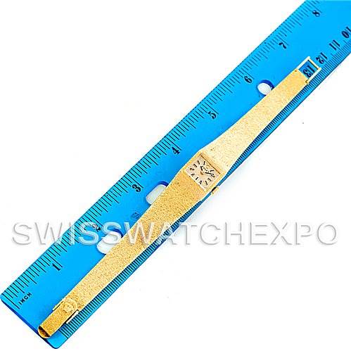 This image shows a Rolex Cocktail 4281 Women's Yellow Gold Champagne Dial 4281 Women's Yellow Gold Champagne Dial model watch lying flat next to a blue ruler, displaying its bracelet and face.