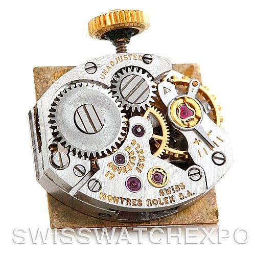 This image shows the internal mechanics of a Rolex Cocktail 4281 Women's Yellow Gold Champagne Dial 4281 Women's Yellow Gold Champagne Dial model watch from a top-down angle, displaying gears and the crown.