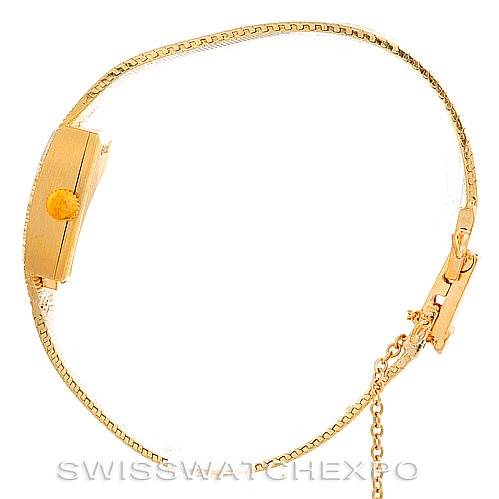 The image shows a Rolex Cocktail 8422 Women's Yellow Gold Champagne Dial 8422 Women's Yellow Gold Champagne Dial model watch laid flat, focusing on its band and clasp.