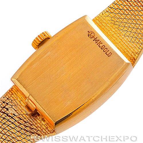 This image shows the case back and a portion of the bracelet of the Rolex Cocktail 8422 Women's Yellow Gold Champagne Dial 8422 Women's Yellow Gold Champagne Dial model watch, highlighting its 14K gold marking.