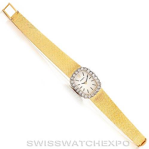 The image displays a top-down view of a Rolex Cocktail Women's Yellow Gold Silver Dial Women's Yellow Gold Silver Dial model watch, featuring a gold band and a diamond-bordered dial.