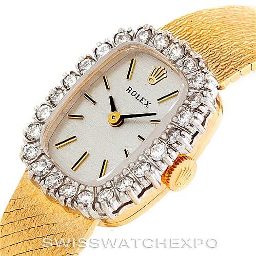 The image shows a close-up, angled view of the Rolex Cocktail Women's Yellow Gold Silver Dial Women's Yellow Gold Silver Dial watch, highlighting the diamond-set bezel, dial, and textured bracelet.