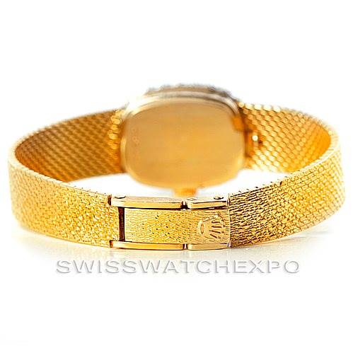 The image shows the back view of a Rolex Cocktail Women's Yellow Gold Silver Dial Women's Yellow Gold Silver Dial model watch, displaying its golden bracelet and clasp.