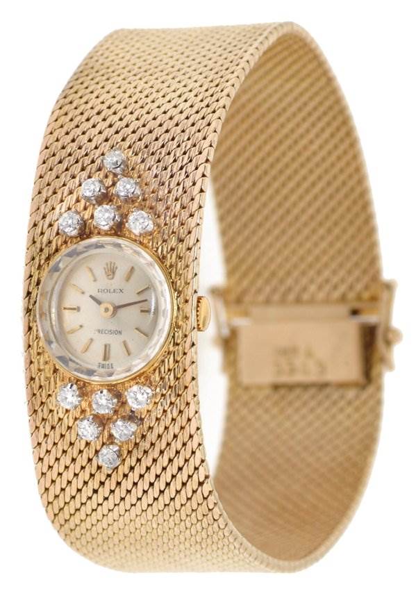 The image shows a Rolex Cocktail 2604 Women's Yellow Gold Silver Dial 2604 Women's Yellow Gold Silver Dial model watch at a slight side angle, highlighting its gold mesh band, diamond accents, and small dial.