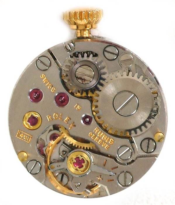 This image shows the internal mechanism of the Rolex Cocktail 2604 Women's Yellow Gold Silver Dial 2604 Women's Yellow Gold Silver Dial model from a top-down angle, highlighting gears and components.