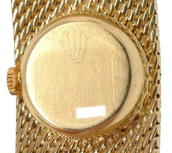 This image shows the back case and partial crown of the Rolex Cocktail 2604 Women's Yellow Gold Silver Dial 2604 Women's Yellow Gold Silver Dial model watch in a close-up view.