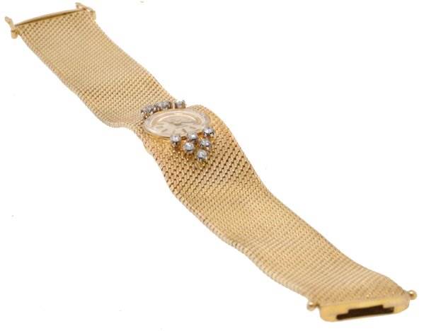 The image shows a Rolex Cocktail 2604 Women's Yellow Gold Silver Dial 2604 Women's Yellow Gold Silver Dial model watch at a slight side angle, focusing on its gold mesh band and diamond-accented face.