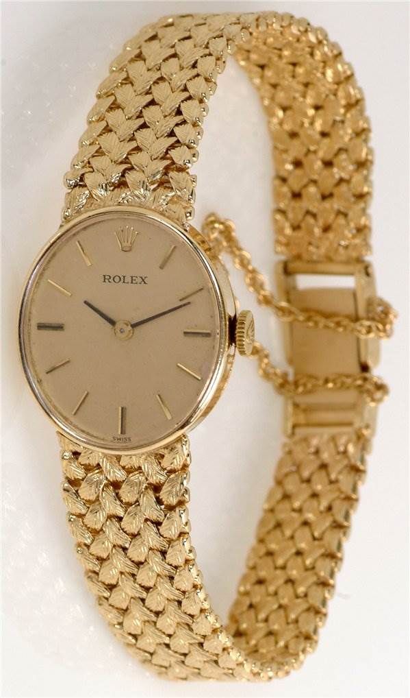 The image shows a Rolex Cocktail Women's Yellow Gold Champagne Dial Women's Yellow Gold Champagne Dial model watch from a front angle, highlighting its gold case, dial, and intricately woven bracelet.