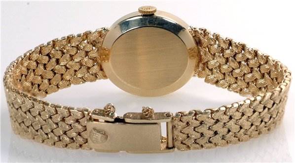 The image shows the back view of a Rolex Cocktail Women's Yellow Gold Champagne Dial Women's Yellow Gold Champagne Dial model watch, including the clasp and bracelet.