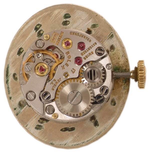 This image shows the internal mechanism of a Rolex Cocktail Women's Yellow Gold Champagne Dial Women's Yellow Gold Champagne Dial model watch, including gears and moving parts, from a top-down angle.