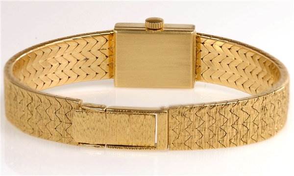 This image shows the back view of a Rolex Cocktail 173J Women's Yellow Gold Silver Dial 173J Women's Yellow Gold Silver Dial model watch, highlighting its gold-toned bracelet and clasp.