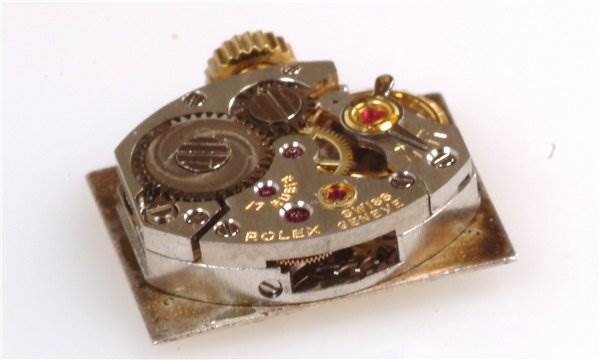 This image shows an internal movement of a Rolex Cocktail 173J Women's Yellow Gold Silver Dial 173J Women's Yellow Gold Silver Dial model watch, showcasing gears and mechanical parts.