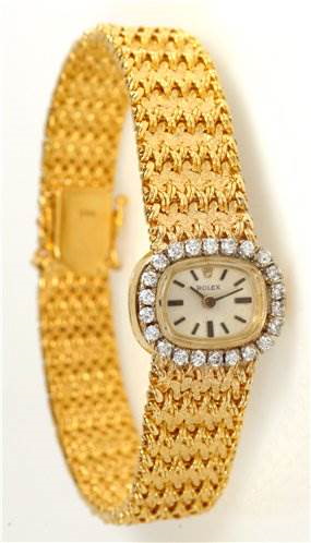 The image shows a Rolex Cocktail model watch, featuring a front angle that highlights its diamond-encrusted dial and gold bracelet.