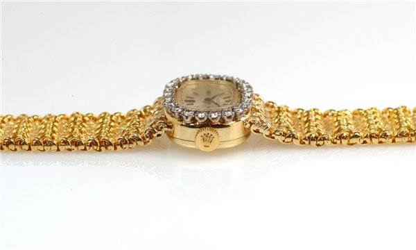 The image shows a side view of the Rolex Cocktail 231 Women's Yellow Gold Silver Dial 231 Women's Yellow Gold Silver Dial model watch, highlighting its gold band and diamond-encrusted bezel.