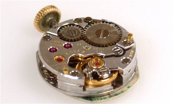The image shows the internal mechanical movement parts of a Rolex Cocktail 231 Women's Yellow Gold Silver Dial 231 Women's Yellow Gold Silver Dial model watch at an angled top-down view.