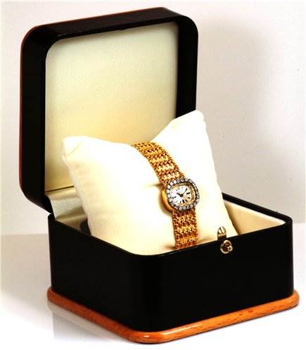 The Rolex Cocktail 231 Women's Yellow Gold Silver Dial 231 Women's Yellow Gold Silver Dial model watch is displayed at an angle inside an open luxury watch box, showing the entire watch and part of the box.