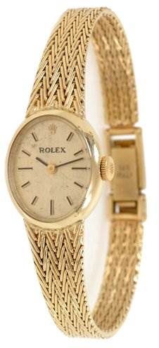 This image shows a side view of the Rolex Cocktail 8415 Women's Yellow Gold Champagne Dial 8415 Women's Yellow Gold Champagne Dial model wristwatch, highlighting the face, case, crown, and part of the bracelet.