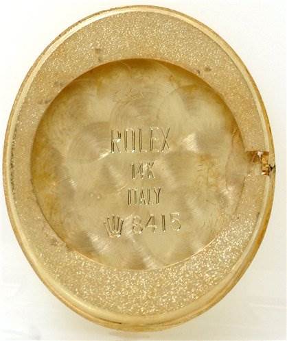 The image shows the case back of a Rolex Cocktail 8415 Women's Yellow Gold Champagne Dial 8415 Women's Yellow Gold Champagne Dial watch, highlighting the "Rolex" and "14K" engravings.